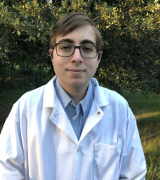 Daniel in a lab coat